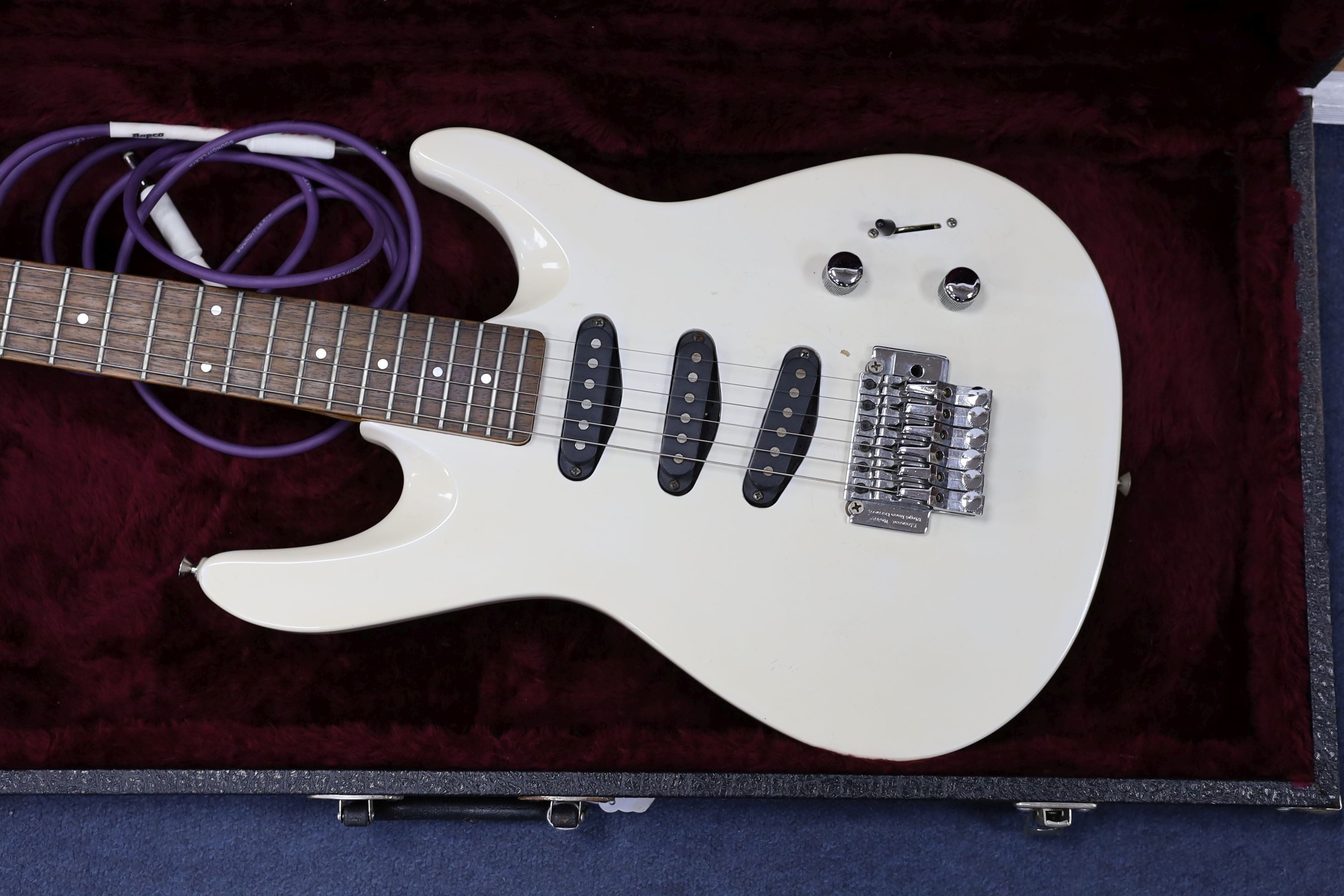 A Washburn KC-30v electric guitar in hard case